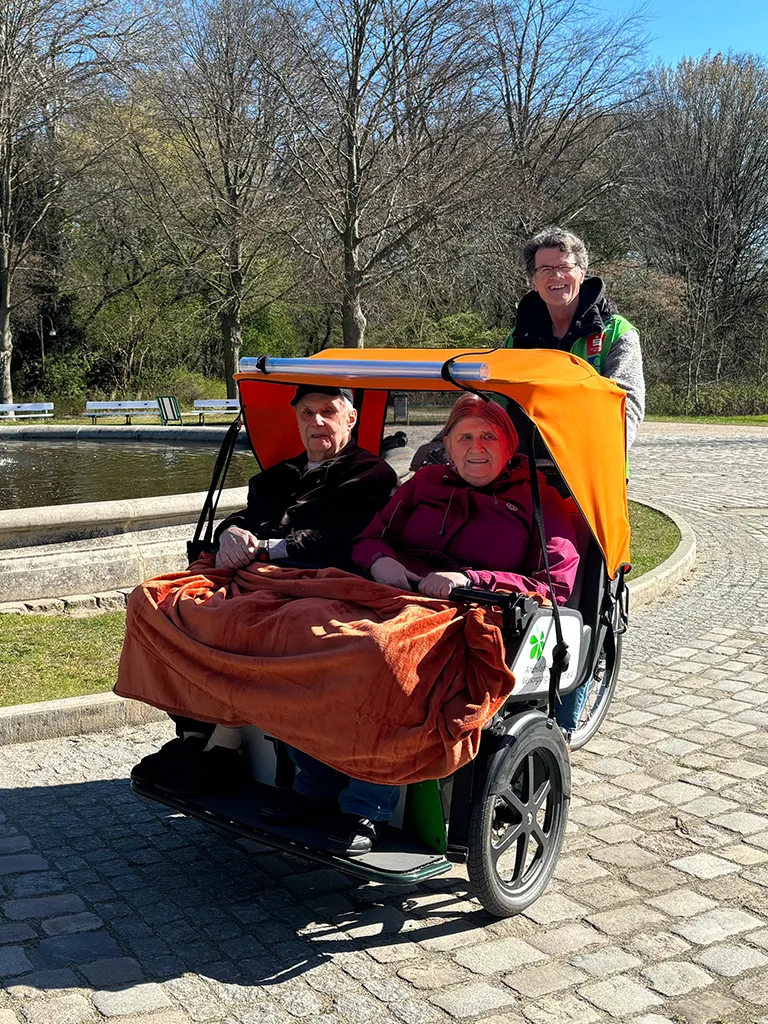 Senior couple in a transport vehicle smiling at the camera (Photo)