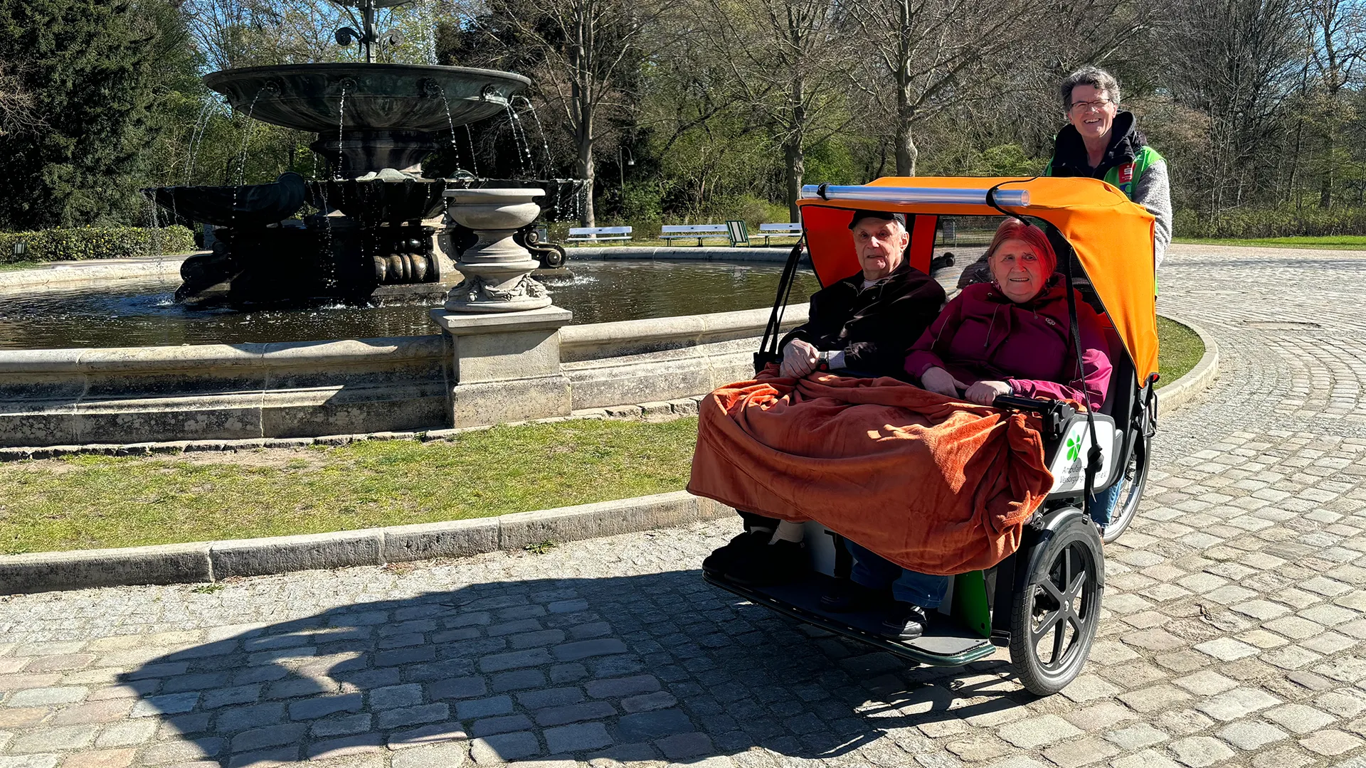 Senior couple in a transport vehicle smiling at the camera (Photo)