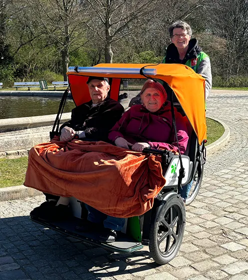 Preview image, senior couple in a transport vehicle smiling at the camera (Photo)